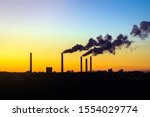 factories smoke from pipes at sunset