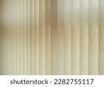 Small photo of Textile texture. Ambient natural light graduated with blinds with adjustable vertical slats made of fireproof fabric and placed on the large windows