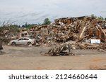 A destroyed apartment building  and vehicles in the aftermath of an EF 4 tornado that hit Tuscaloosa on April 27, 2011.