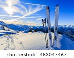 Ski in winter season, mountains and ski touring equipments on the top at sunrise.