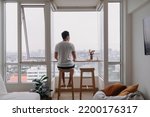 Small photo of Lonely asian man sit by windows in the room. Concept lonely single broken heart.