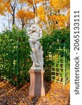 Small photo of Sculpture of Summer garden in autumn foliage, Saint Petersburg, Russia (inscription "Salacity")