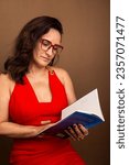 Small photo of Coaching woman, concentrated reading motivational book. Nonviolent communication concept. Isolated on brown background.