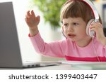 Little girl wearing headphones using computer aggressive articulating portrait