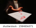 Small photo of Businessman in suit throws his hand playing card ace of worms to opponent on a black background. Winning in business payout concept