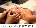 Small photo of Woman is given rejuvenating facial massage in an aroma room. Relaxing facial massage techniques concept