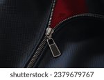Small photo of Closeup of steel zipper on leather jacket. Zipper replacement services concept