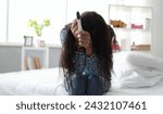 Small photo of Girl sitting at home upset because pregnancy test. Father insecurity. Unplanned pregnancy. Result negligence. Home version lab test. Woman learns about conception at an early date