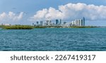 Sunny Isles, Florida- Panorama of coastal cityscape against the giant puffy clouds in the background. Views of sea water at the front and modern high-rise buildings at the back.