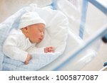 Beautiful newborn baby boy, laying in crib in prenatal hospital