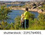 Happy people, enjoying amazing views in South Norway coastline, fjords, lakes, beautiful nature. Kids and adults traveling in Norway summertime