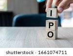 Small photo of Businessman hand holding IPO (Initial Public Offering) word with wooden cube block, shares of a private corporation to the public in a new stock issuance. Stock, Fund, Investors and Investment concept