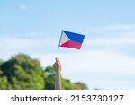 Small photo of hand holding Philippines flag on nature background. 12th June of Independence day and happy celebration concepts