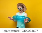 Small photo of young guy with an inflatable swim ring is bound and limited in action and freedom, a man on vacation in the summer is constrained and shocked, concept
