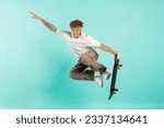 Small photo of young crazy guy rides skateboard and jumps on blue isolated background, hipster in sunglasses flies with skateboard in the air and does extreme trick
