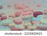 Small photo of electrocardiogram with atrial fibrillation superimposed on colored pills concept of treatment of cardiac arrhythmias