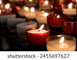 Votive prayer candles inside a...