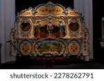 Small photo of Utrecht, The Netherlands - March 2023: Mobile richly decorated in pristine condition peal chime carillon barrel organ on display in museum