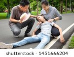 Small photo of Asian little child girl with heat stroke,high temperature,sick daughter having exhausted suffering from sunburn very hot in summer outdoor, feeling faint,father and mother assisting