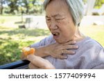 Small photo of Asian senior woman suffers from choke and cough,clogged up food,elderly people choking during feeding,food might stuck in the throat and suffocate ,health problem, asphyxia,suffocation concept