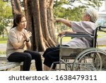 Small photo of Angry senior person in wheelchair has quarrel violently with aggressive caregiver woman at outdoor nursing home,female elderly arguing yell at each other,ungrateful,bad relations,conflict concept