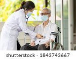 Small photo of Service and health examination,old elderly with Gastroenteritis,abdominal problems,asian female doctor using a stethoscope,listen to sound of the abdomen,senior woman with flatulence,bloated stomach