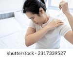 Small photo of Asian middle aged woman suffering from frozen shoulder,pain and stiffness,unable to move,difficulty lifting his arm,female people with calcific tendonitis,shoulder injuries,health care,medical concept