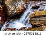 Movement of river water flowing between rocks in the rainforest in Minas Gerais, Brazil