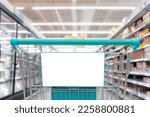 Blank banner attached to shopping cart, copy space with shopping cart on supermarket background for creative design, copy space to use in advertising communication