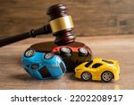 Small photo of Hammer gavel judge with car vehicle accident, insurance coverage claim lawsuit court case.