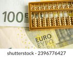 Gold abacus on Euro banknote money, economy finance exchange trade investment concept.