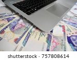 Naira. Laptop on Nigerian Naira notes for internet fraud concept
