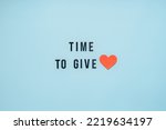 Small photo of Giving Tuesday, Time to Give, Help, Donation, Support, Volunteer concept with red heart and text Time to Give on blue background. Its time to give