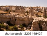 Small photo of Famous Phallic shaped rock formations known as fairy chimneys in Zerve valley, caused by volcanoes, near Goreme, Cappadocia, Anatolia, Turkey