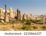Small photo of Famous Phallic shaped rock formations known as fairy chimneys in Love Valley, caused by volcanoes, near Goreme, Cappadocia, Anatolia, Turkey