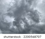 Small photo of Nimbostratus clouds form through the deepening and thickening Formed with a strange shape of an altostratus cloud, often along warm or occluded fronts and causing rain and thunder at Bangkok, Thailand