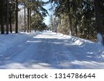 Small photo of Plowers have their work cut out for them this winter in Ashland, Wis. Beautiful snowy road through the woods of Pretence Park on a bright day in February.