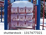 Small photo of Frozen tic-tac-toe game at a red and blue kids' playground in winter. Pretence Park, Ashland, Wis.