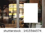 Small photo of Mockup white paper or white promotion poster displayed on the front of the restaurant, coffee shop Promotion information for marketing announcements and details