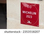 Small photo of saint-emilion , France - 08 19 2023 : Michelin 2023 restaurant logo sign and text brand of guides books published for good place label with good food