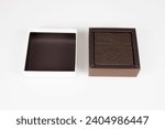 Small photo of brown open chocolate Gift Box with cower in white background