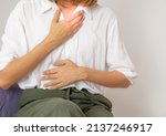 Small photo of woman suffering heartburn and acid reflux and squeamish, health concept