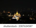Small photo of Bangkok, Thailandland - 9 April 2023: Bangkok landmark at night. Beautiful buddhist temple golden pagoda night view of Wat Saket, the Golden Mount templet from night light in Bangkok, Thailand.