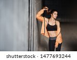 Small photo of Attractive sporty girl with perfect body wear activewear leggings, lean concrete wall turn aside, smiling pleased and motivated, finish productive outdoor training session, runner prepare to marathon