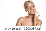 Small photo of Skin care beauty. Young blond woman model moisturize clean skin without makeup, apply body face cream or serum on face, treating acne with cosmetology product, white background.