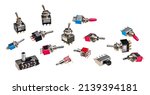 Small photo of Different types of electrical toggle switches isolated on a white background. Collection of miniature electromechanical electronic components with metal on-off lever for use on printed circuit boards.