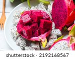 Small photo of dragon fruit slice on white plate with pitahaya background, fresh white and pink red purple dragon fruit tropical in the asian thailand healthy fruit concept