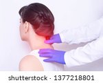Small photo of Doctor neurologist examines the patient's sore neck on a pinched nerve and protrusion of the spine, medical