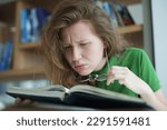 Small photo of tired overworked, exhausted young woman in glasses college or university student is study hard in library, lesson, problem with eyes, myopic purblind. Vision eyes problems, myopia, blindness.