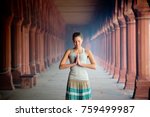 girl meditates hands folded in namaste
